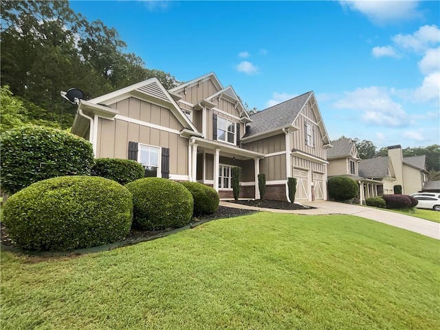200 Pine Trl, Dallas, GA 30157 - view of front of property featuring board and batten siding, concrete driveway, a front yard, and a garage