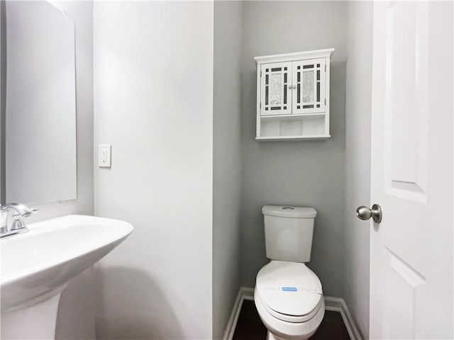 200 Pine Trl, Dallas, GA 30157 - bathroom featuring toilet, a sink, and baseboards