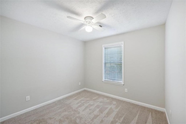 spare room featuring ceiling fan and light colored carpet