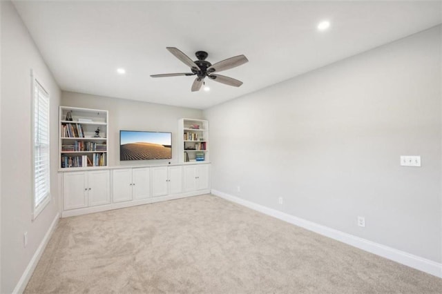 unfurnished living room featuring light carpet and ceiling fan