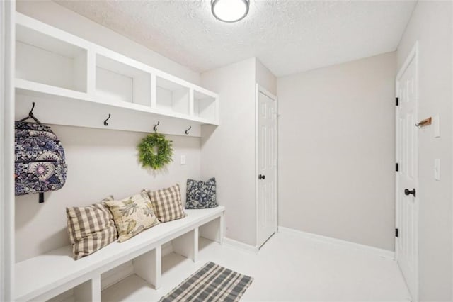 mudroom featuring a textured ceiling