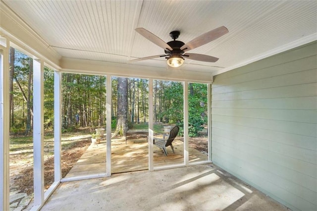 unfurnished sunroom featuring ceiling fan