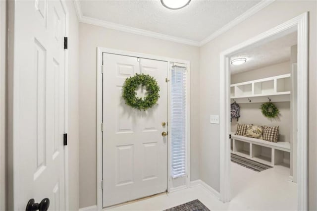 entryway featuring a textured ceiling and ornamental molding