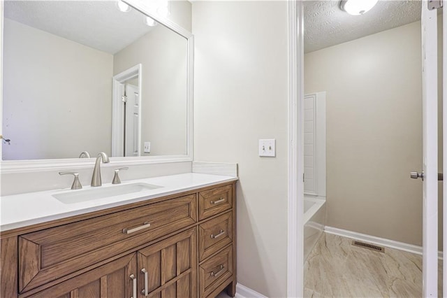 bathroom with vanity, shower / washtub combination, and a textured ceiling