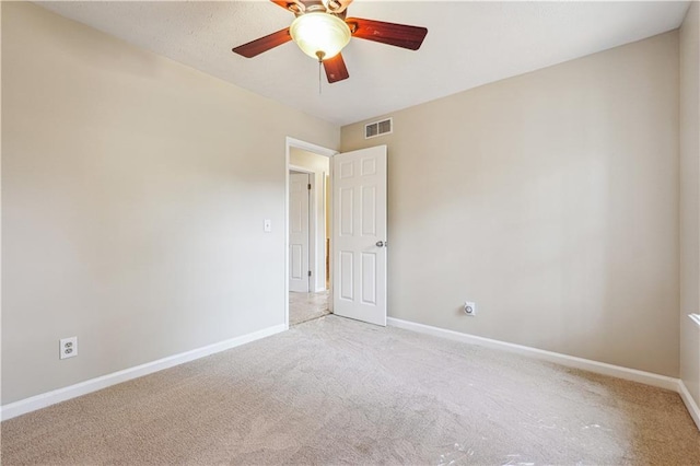 unfurnished room featuring light colored carpet and ceiling fan