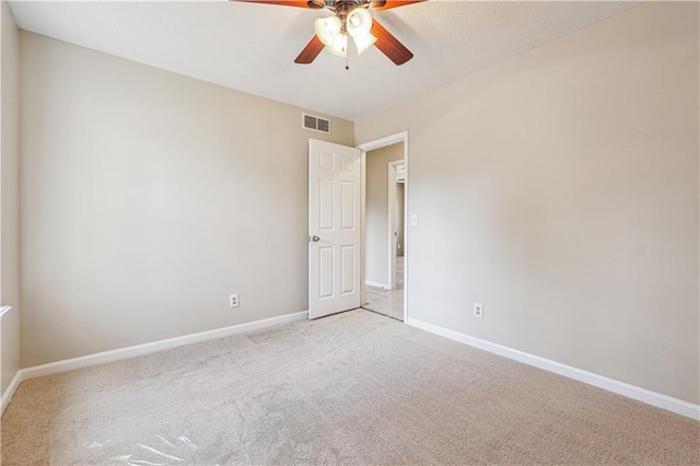 carpeted empty room featuring ceiling fan