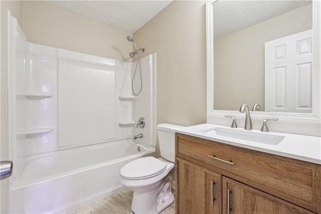 full bathroom with vanity, washtub / shower combination, a textured ceiling, and toilet