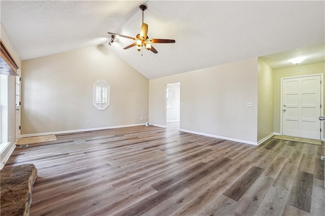 unfurnished living room featuring ceiling fan, wood-type flooring, and vaulted ceiling