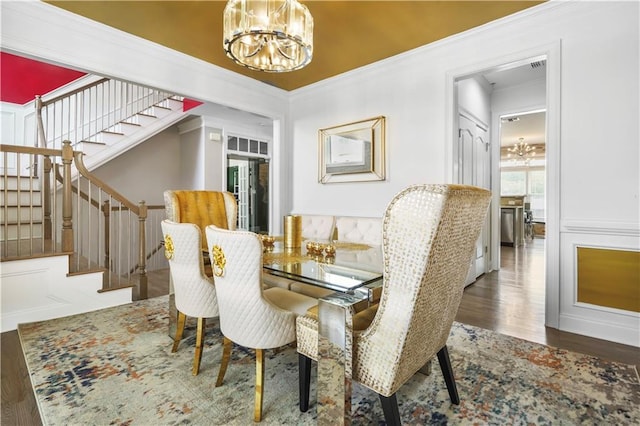 1165 Laurel Pl SE, Smyrna, GA 30080 - dining room with a chandelier, wood finished floors, stairway, crown molding, and a decorative wall