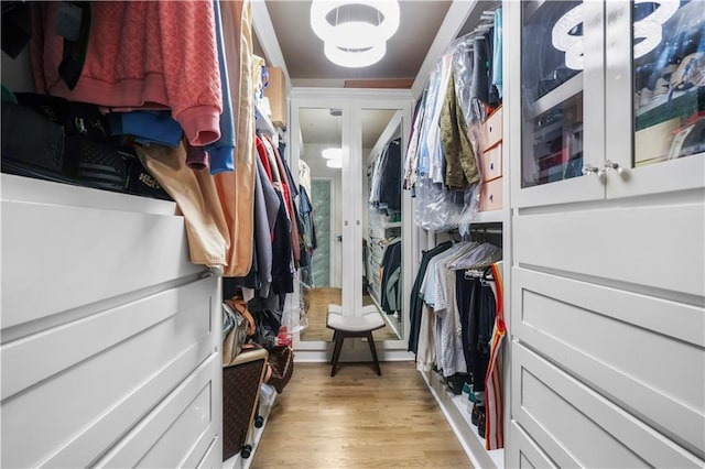 1165 Laurel Pl SE, Smyrna, GA 30080 - walk in closet with light wood-type flooring, a chandelier, and french doors