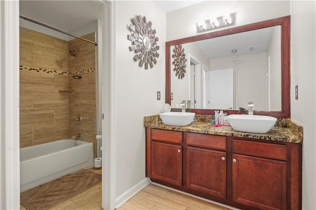 1165 Laurel Pl SE, Smyrna, GA 30080 - bathroom featuring double vanity, wood finished floors, and shower / washtub combination