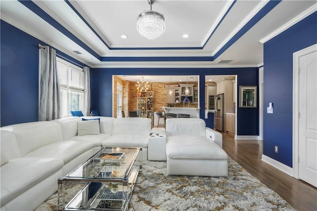 1165 Laurel Pl SE, Smyrna, GA 30080 - living room with a chandelier, a tray ceiling, wood finished floors, and ornamental molding