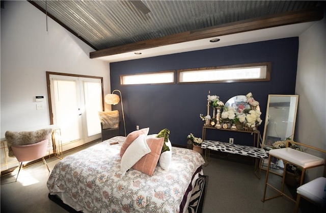 carpeted bedroom with beamed ceiling and french doors