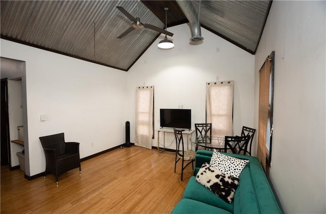 living room featuring hardwood / wood-style flooring, ceiling fan, high vaulted ceiling, and beamed ceiling