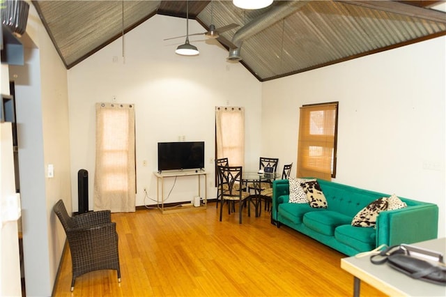 living room with ceiling fan, high vaulted ceiling, and hardwood / wood-style floors