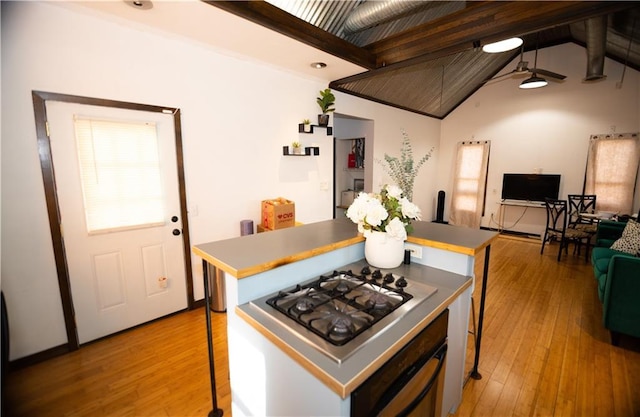 kitchen featuring lofted ceiling, stainless steel gas cooktop, light hardwood / wood-style flooring, a kitchen island, and oven