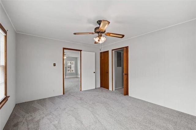 spare room with carpet, a healthy amount of sunlight, and crown molding