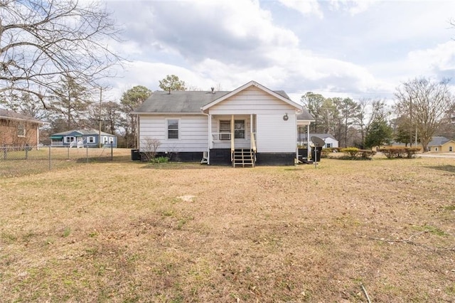 rear view of house with a yard, central AC, and fence