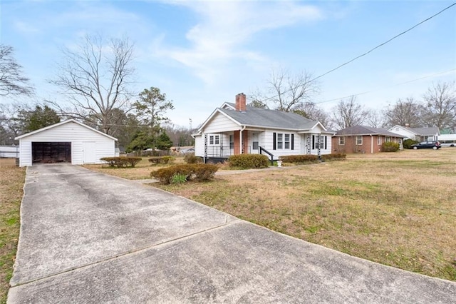 view of front of property with an outbuilding, a chimney, a garage, driveway, and a front lawn