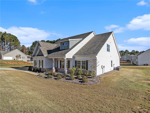 view of front of home with a front yard and central AC unit