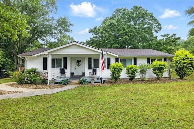 single story home with covered porch and a front yard