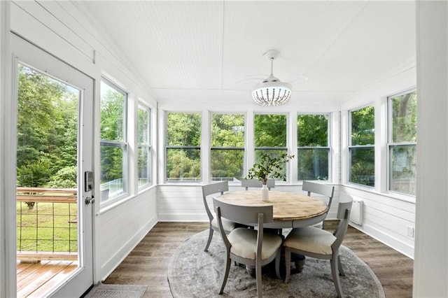 sunroom with wood finished floors and a deck