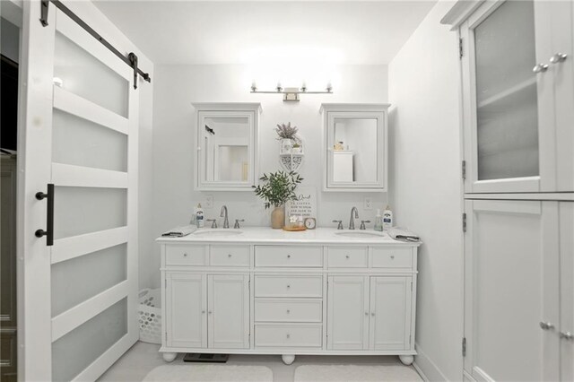 full bathroom with double vanity and baseboards