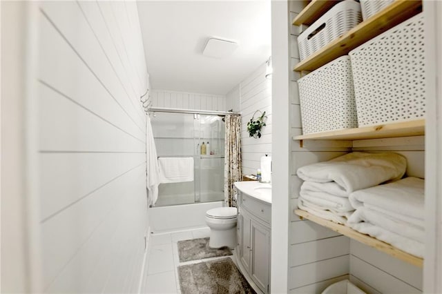 full bath with toilet, shower / bath combo with shower curtain, vanity, and tile patterned flooring