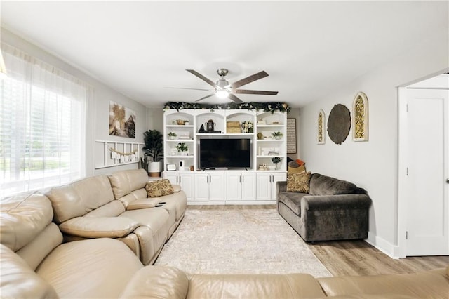 living area featuring ceiling fan and light wood finished floors