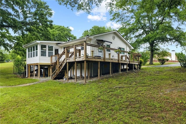 back of house featuring a deck, stairs, a sunroom, and a yard