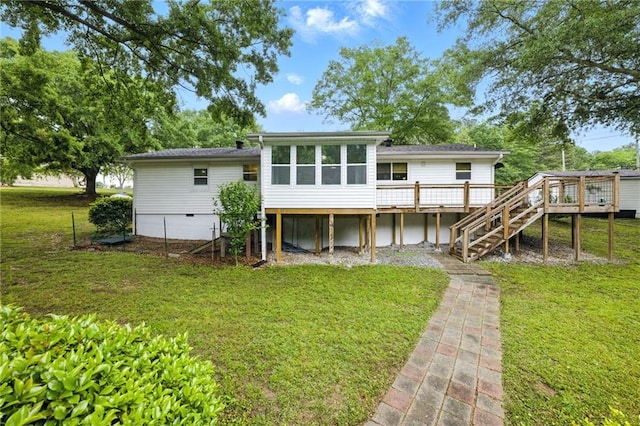 back of house with a deck, stairs, a yard, and a sunroom