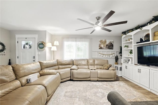 living room featuring ceiling fan and wood finished floors