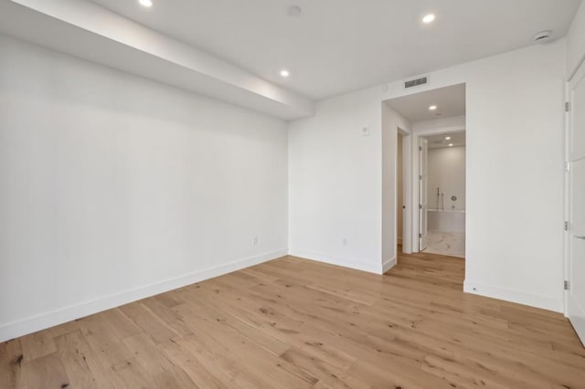 unfurnished room with light wood-type flooring