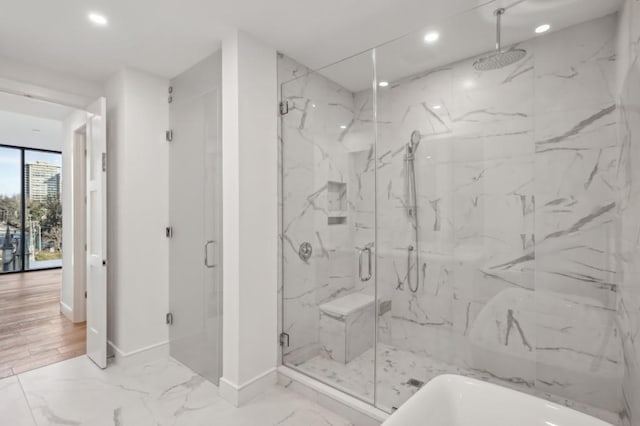 bathroom featuring shower with separate bathtub