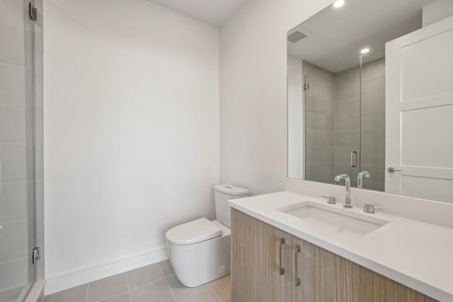 bathroom with tile patterned floors, toilet, vanity, and walk in shower