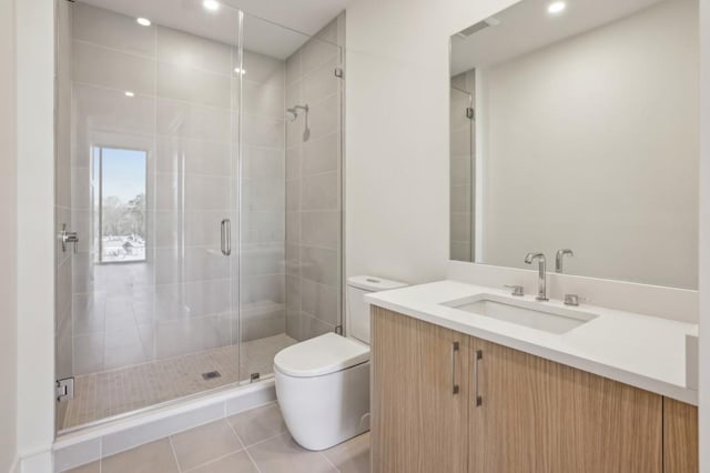 bathroom featuring tile patterned flooring, vanity, toilet, and walk in shower