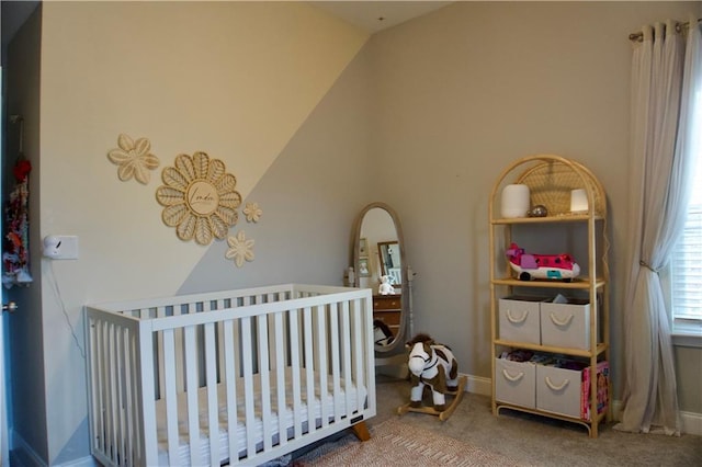 bedroom featuring carpet flooring and a crib