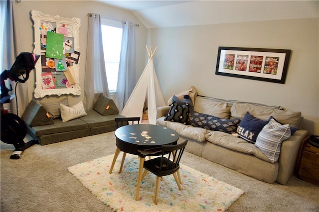 living room featuring vaulted ceiling and carpet