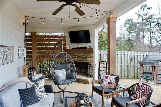 view of patio with ceiling fan and an outdoor stone fireplace