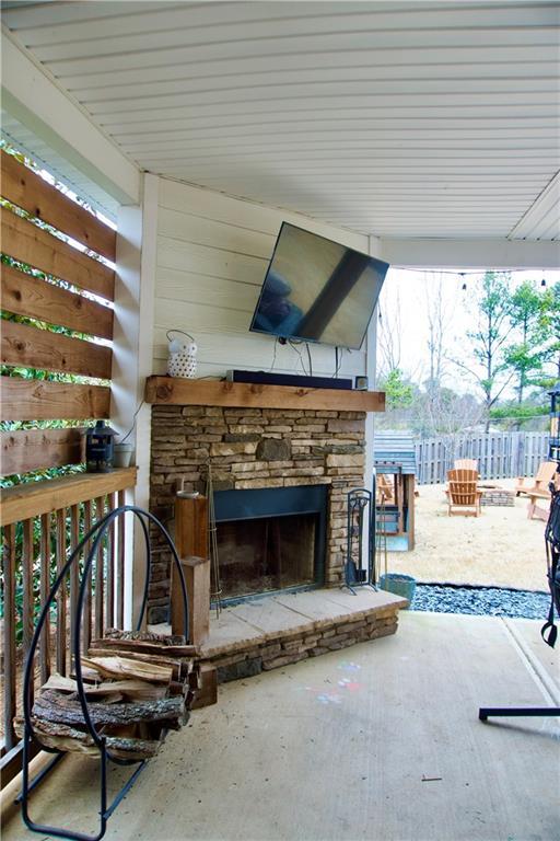 view of patio with an outdoor stone fireplace