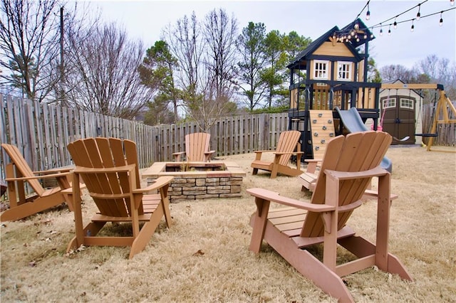 view of patio featuring an outdoor fire pit and a playground