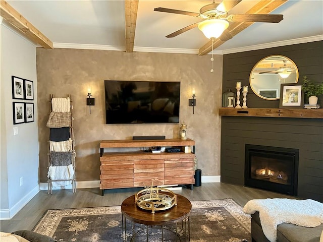 living room with beamed ceiling, ornamental molding, and wood-type flooring