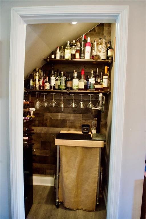 bar with dark wood-type flooring