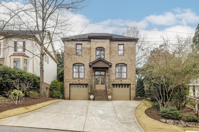 view of front of house with a garage, french doors, concrete driveway, and brick siding