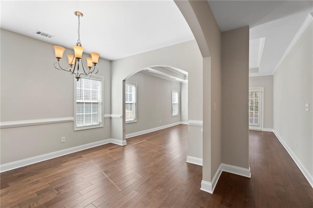 unfurnished dining area with dark hardwood / wood-style floors and an inviting chandelier