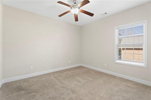 spare room with carpet floors and ceiling fan