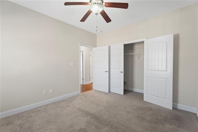 unfurnished bedroom featuring light colored carpet, a closet, and ceiling fan