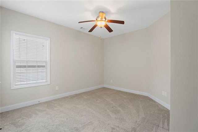 carpeted spare room with ceiling fan