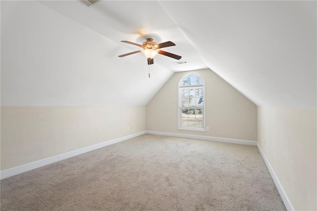 additional living space featuring ceiling fan, light colored carpet, and lofted ceiling