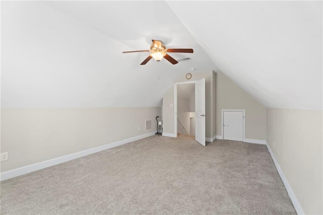 bonus room with light carpet, vaulted ceiling, and ceiling fan